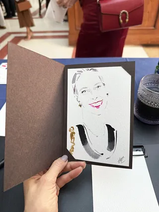 Hand holding a live event portrait illustration by Elise Lee