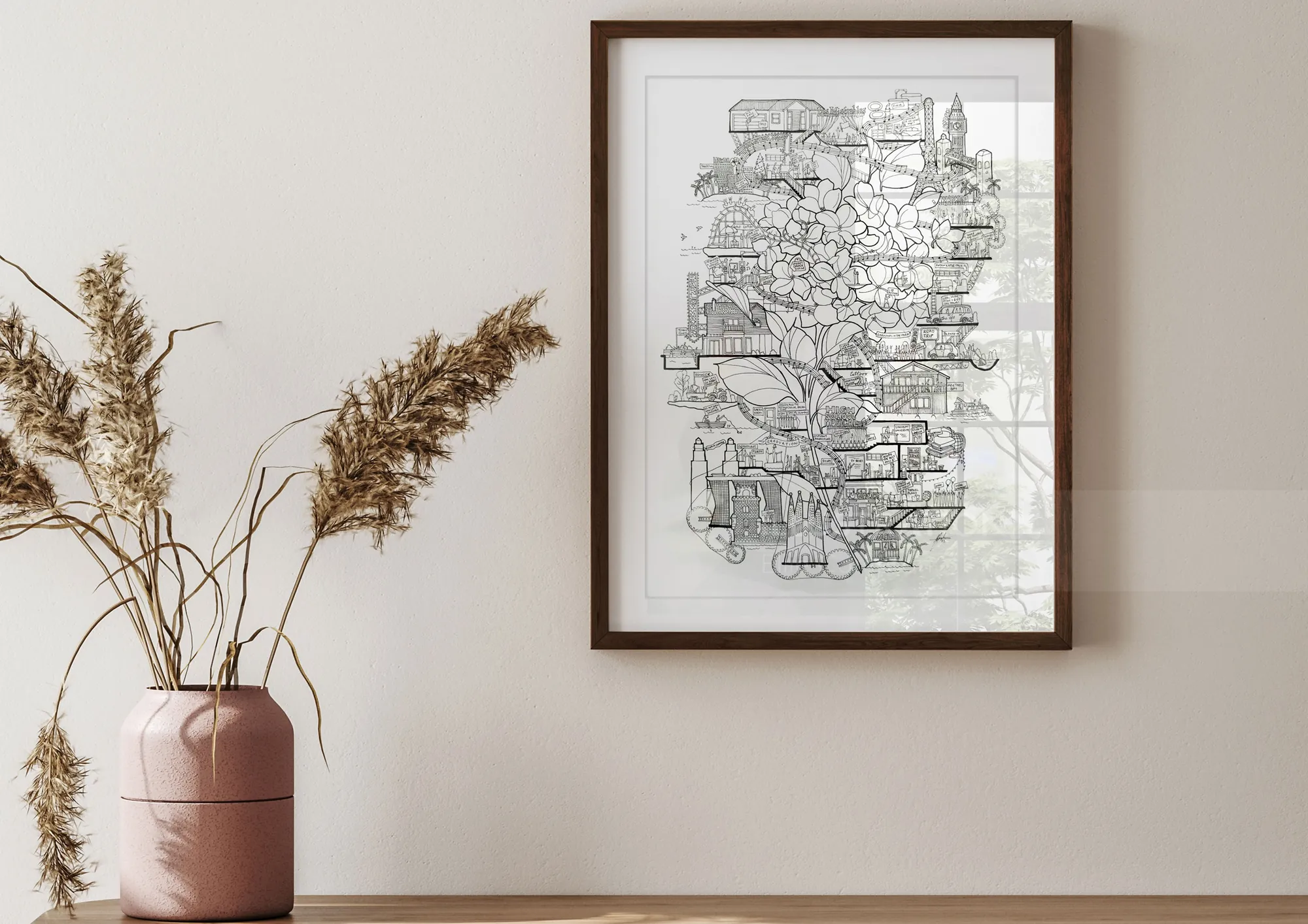 Framed line art map hanging on wall above table with pink vase and dried plants by Ellie Compton