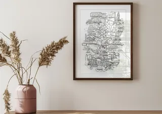 Framed line art map hanging on wall above table with pink vase and dried plants by Ellie Compton