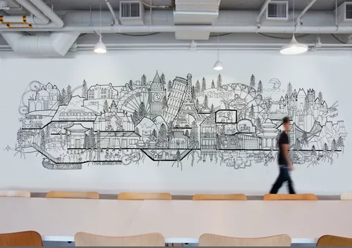 Cityscape mural in black and white on wall with person walking by, artist Ellie Compton