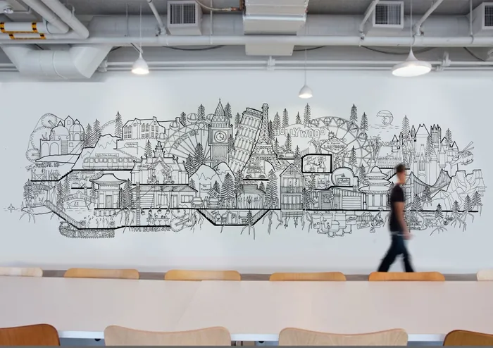 Cityscape mural in black and white on wall with person walking by, artist Ellie Compton