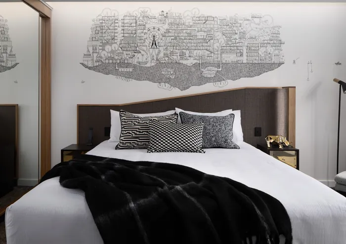 Modern bedroom with detailed city map mural by Ellie Compton above headboard