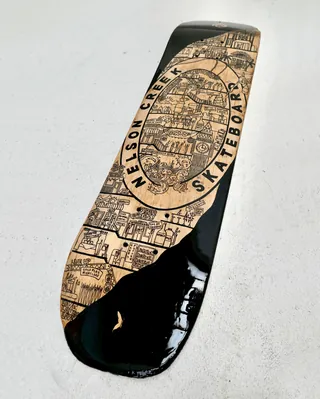 Skateboard deck with Nelson Creek map design by Ellie Compton