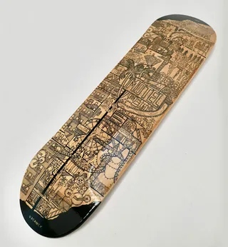 Intricately etched wooden skateboard deck by Ellie Compton