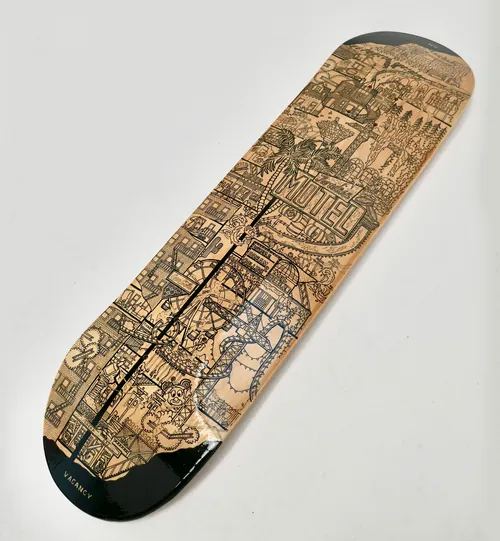 Intricately etched wooden skateboard deck by Ellie Compton