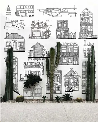 Wall mural with various architectural sketches and cacti by Ellie Compton