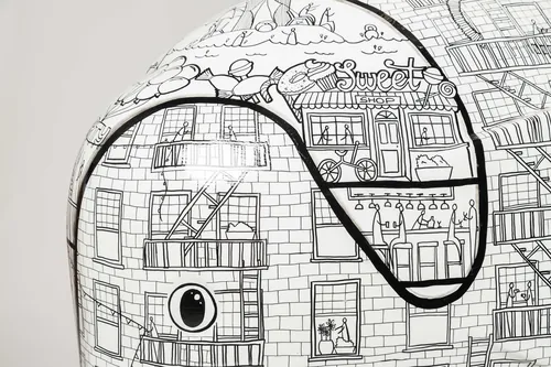 Detailed black and white cityscape drawing on curved object