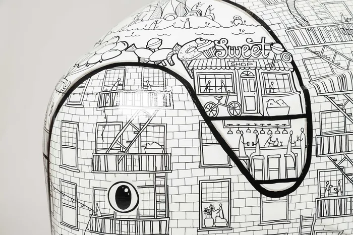 Detailed black and white cityscape drawing on curved object