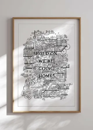 Framed black and white city map art with text 'Hold on we're going home'.