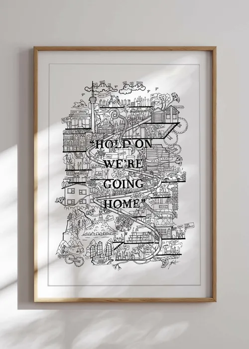 Framed black and white city map art with text 'Hold on we're going home'.