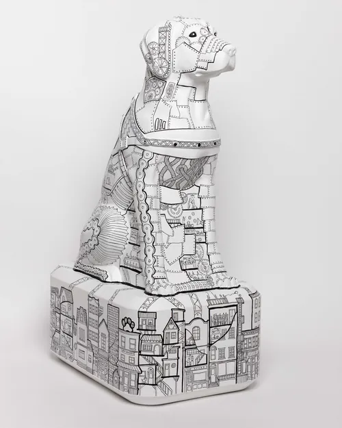 Detailed black and white geometric dog sculpture on pedestal