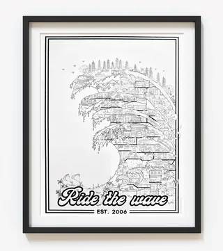 Framed black and white art showing a detailed wave with city elements
