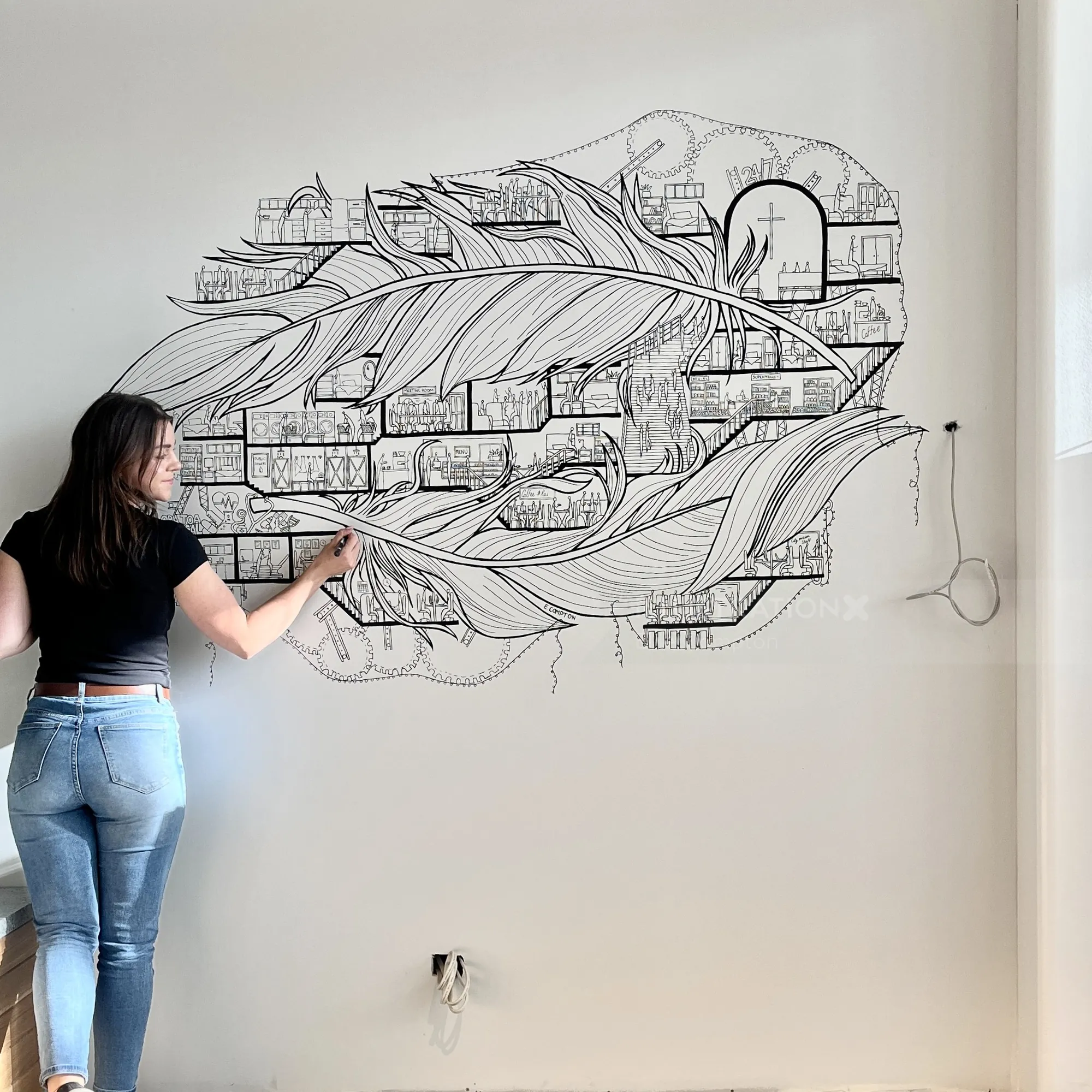 艺术家在墙上创作黑白抽象羽毛壁画