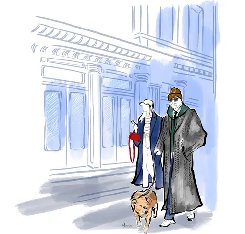 Two people walking a dog on a city street with tall buildings