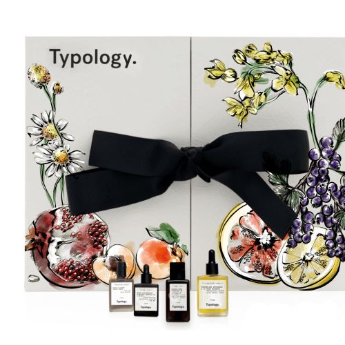 Typology fragrance set with floral artwork and tied with a black bow by Elly Azizian