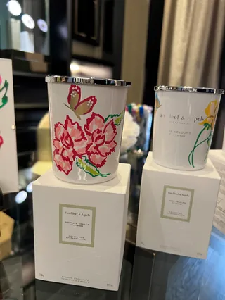 White candle containers with pink and yellow floral designs by Elly Azizian