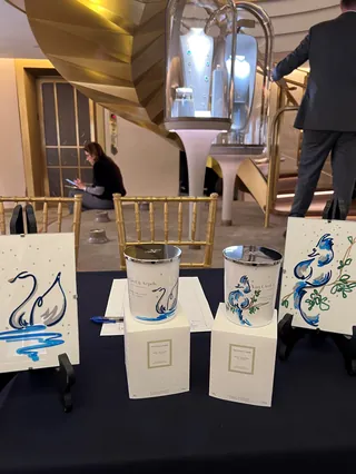 Watercolor paint cans and swan paintings by Elly Azizian