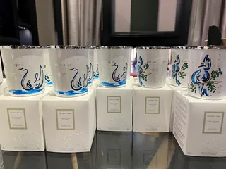 Hand-painted glassware displayed on white boxes, artwork by Elly Azizian