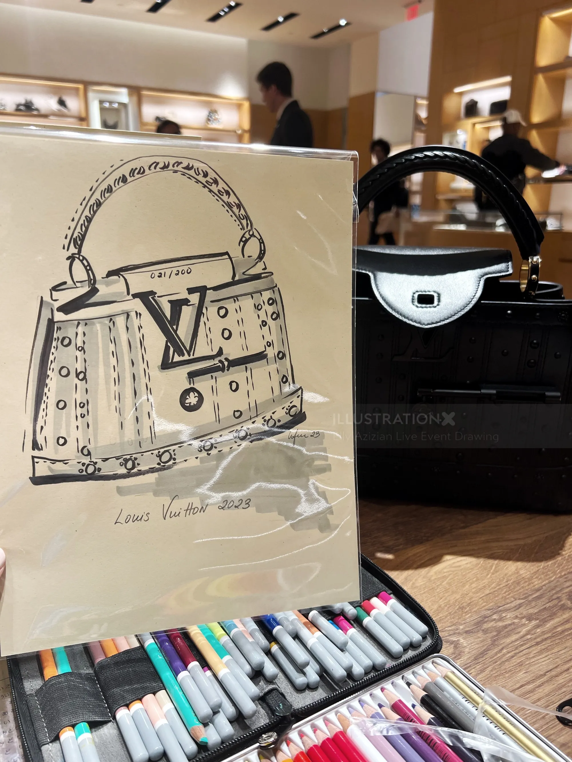 Sketch of a Louis Vuitton handbag by Elly Azizian with real bag in background