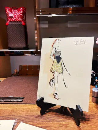 Fashion illustration on easel by Elly Azizian at live event