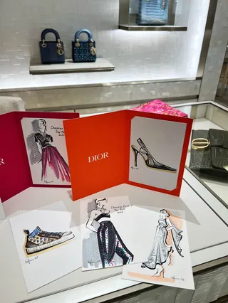 Fashion sketches and shoe designs displayed with Dior branding by Elly Azizian