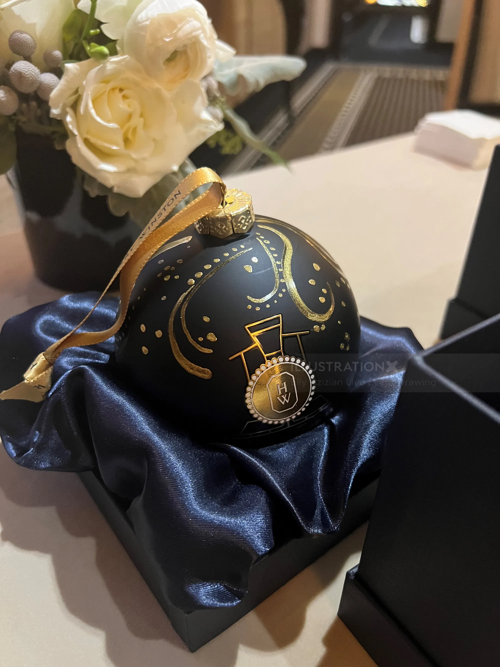 Black Christmas ornament with gold music notes next to white roses