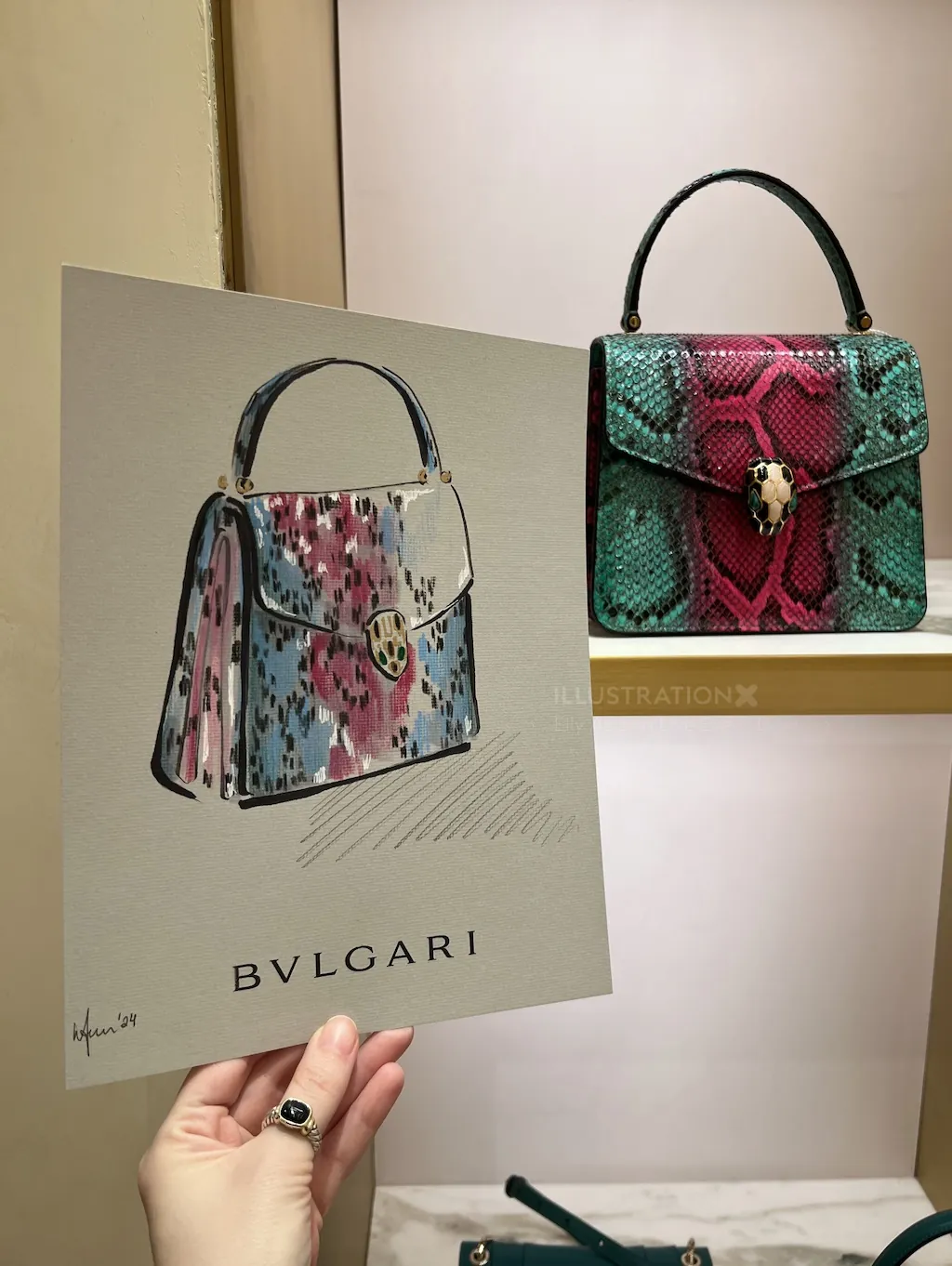 Hand holding Bvlgari handbag illustration with real handbag behind