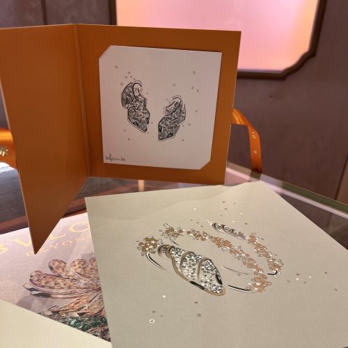 BVLGARI jewelry brochure and card with artistic design on table