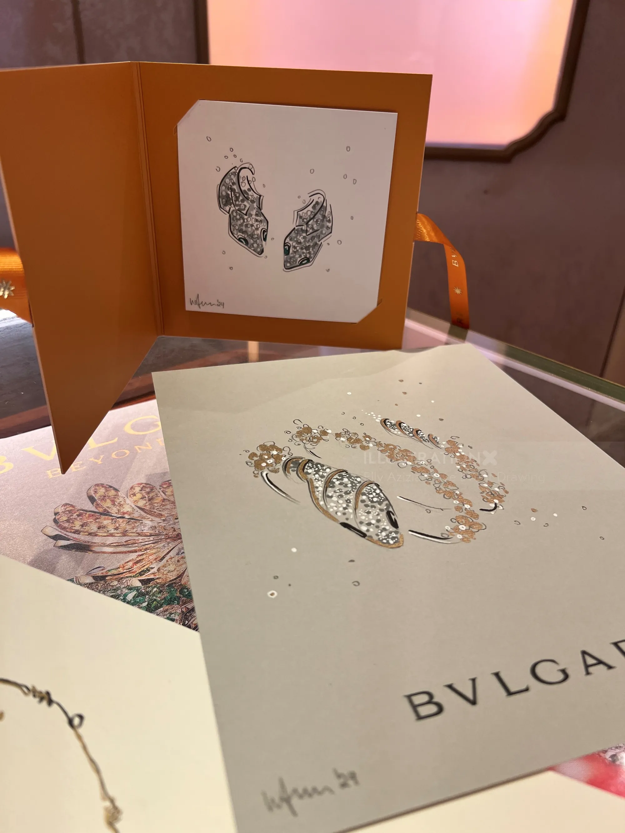 BVLGARI jewelry brochure and card with artistic design on table
