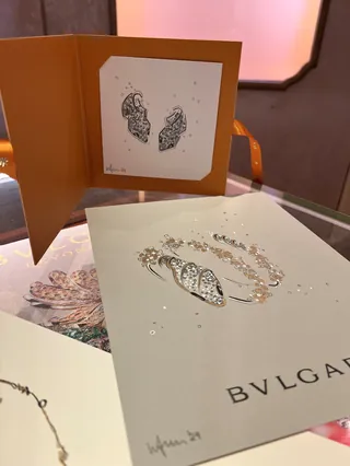 BVLGARI jewelry brochure and card with artistic design on table