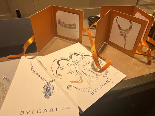 BVLGARI jewelry sketches and portraits on paper with orange folders