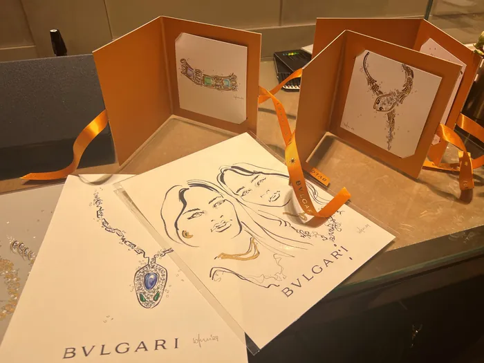 BVLGARI jewelry sketches and portraits on paper with orange folders
