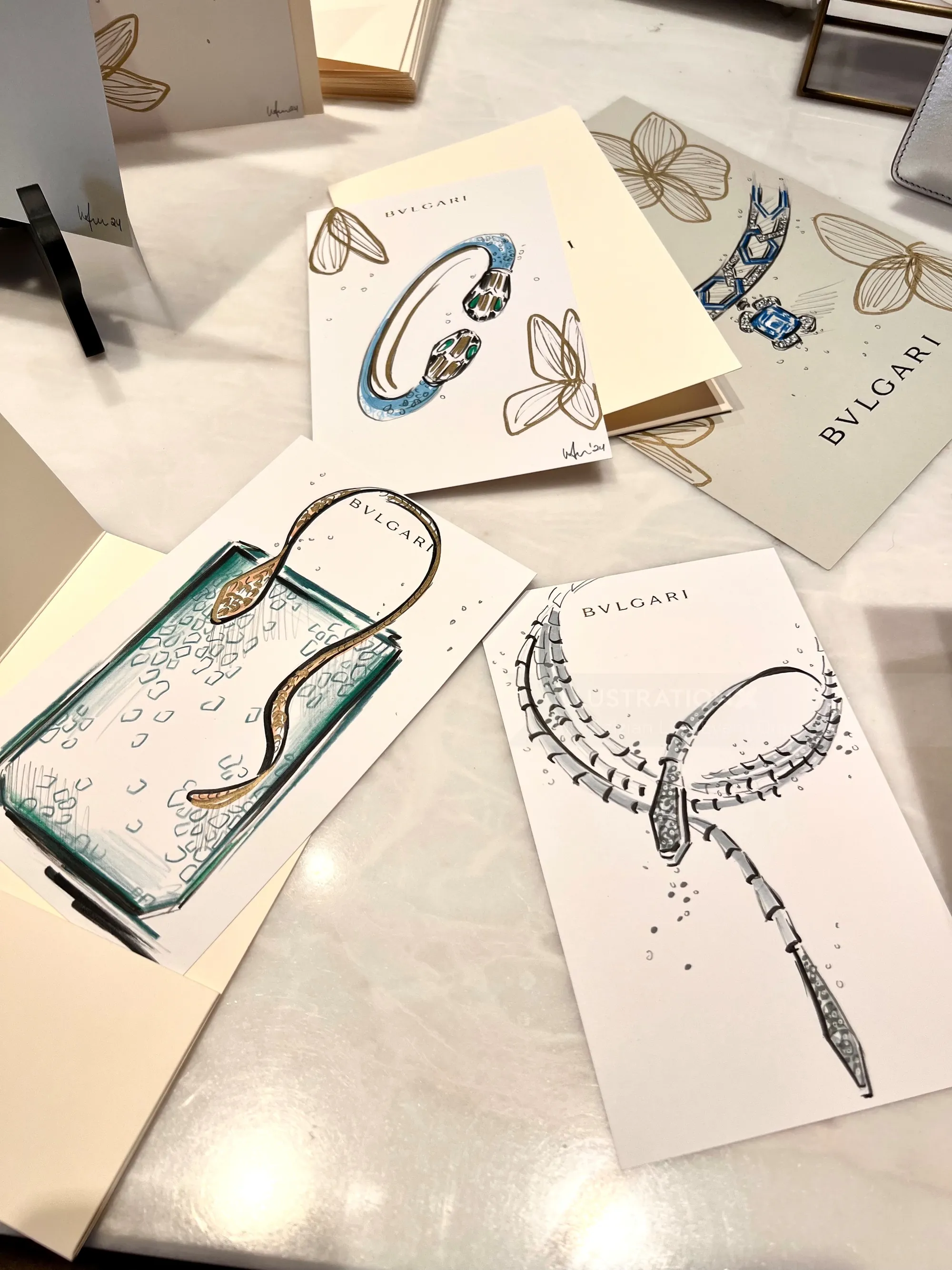 BVLGARI jewelry design sketches on display cards on a table