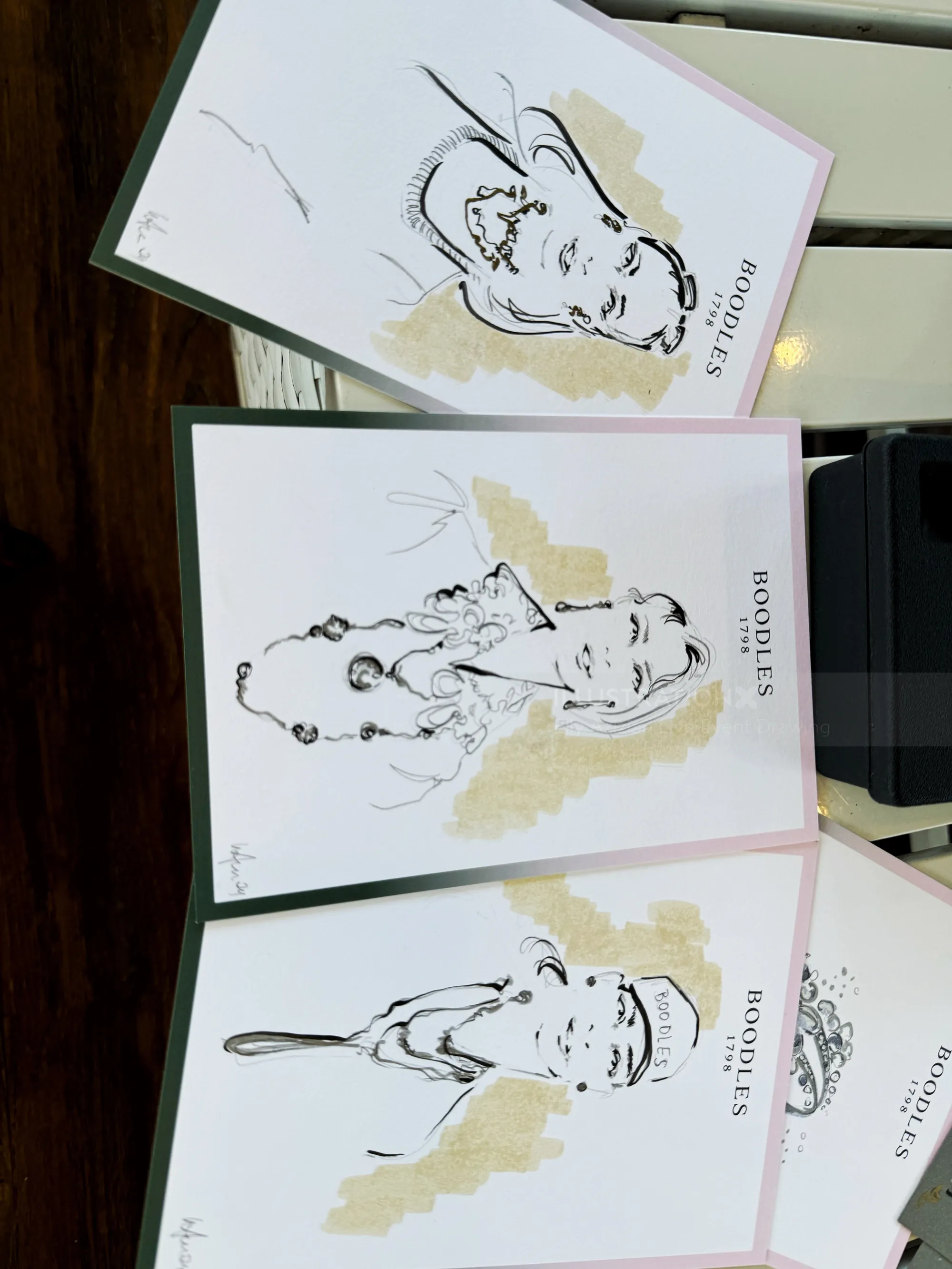 Three abstract portraits with gold highlights on white paper