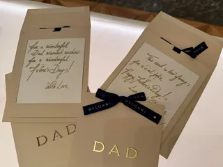 Father's Day cards with gold text and navy BVLGARI ribbons