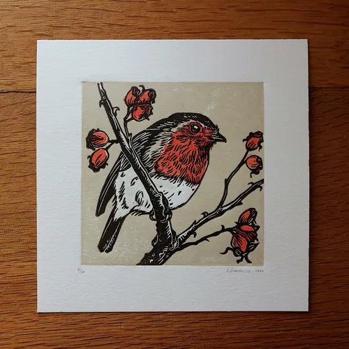 Hand-printed lino cut artwork of a robin and rose hips
