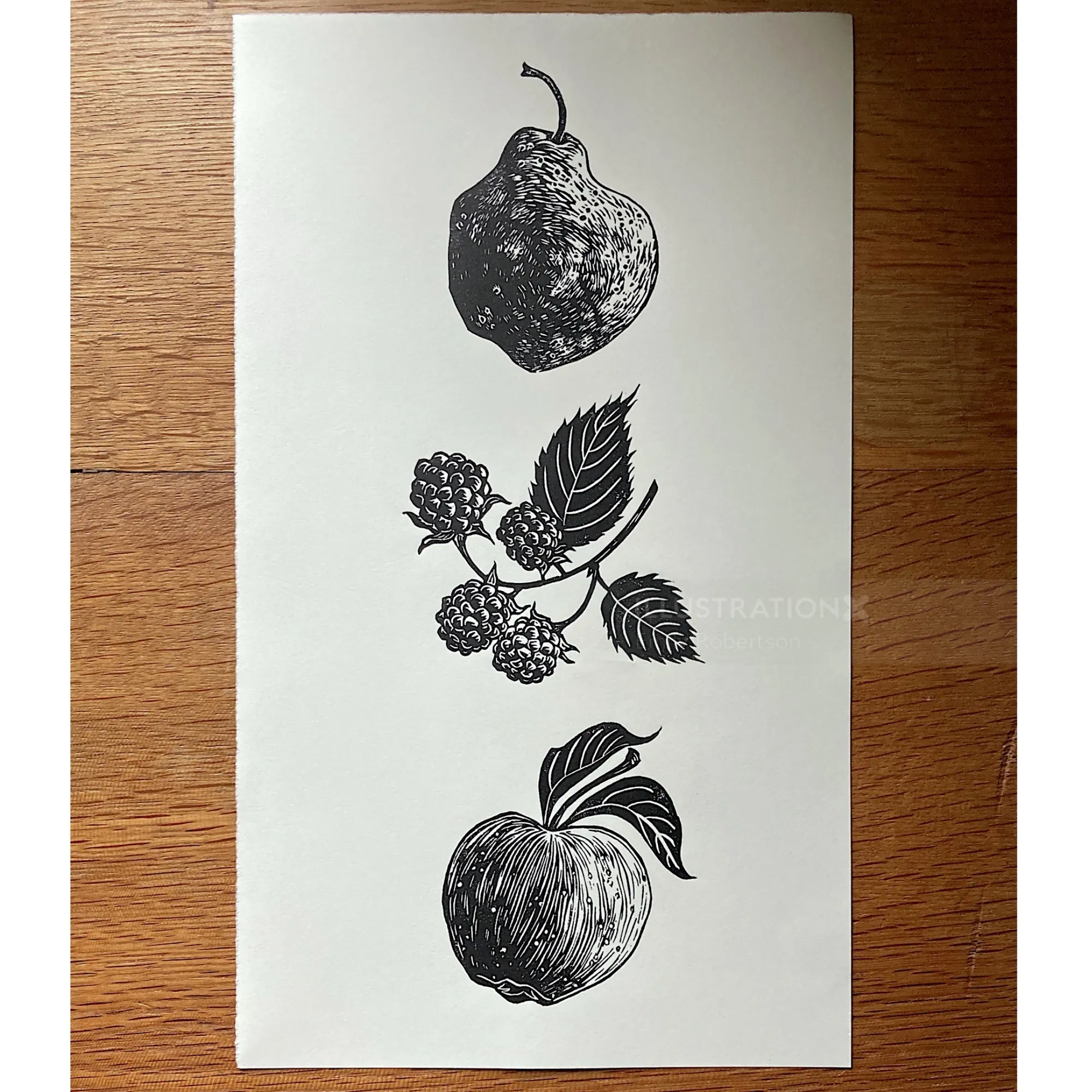 Lino print of a pear, blackberries, and an apple by Emily Robertson