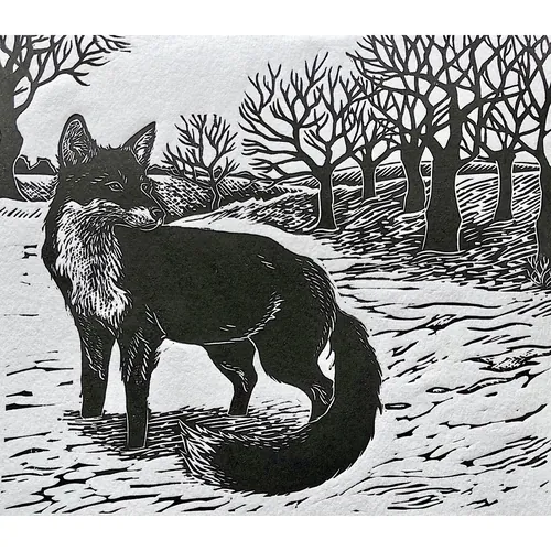 Lino print of a black fox in a snowy landscape by Emily Robertson