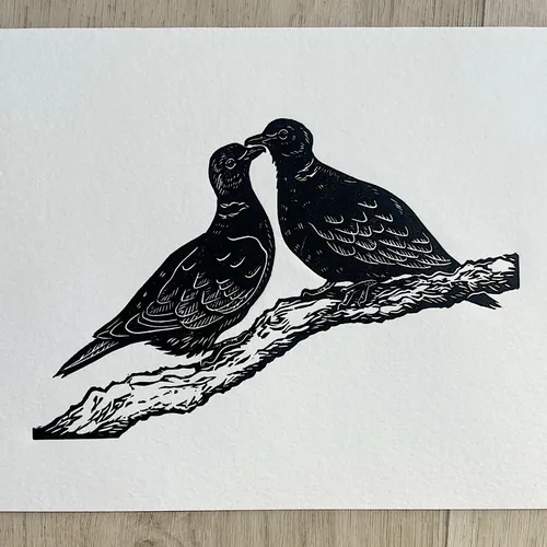 Black lino cut of two turtle doves on a branch by Emily Robertson