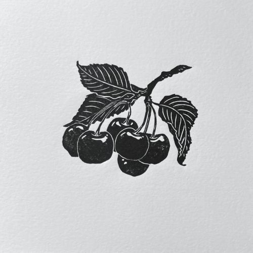 Lino cut print of a cherry sprig with leaves by Emily Robertson