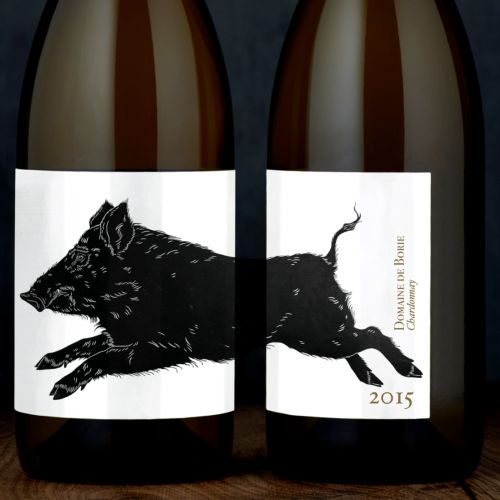 Wine bottle label with lino cut print of a leaping boar by Emily Robertson