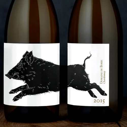 Wine bottle label with lino cut print of a leaping boar by Emily Robertson