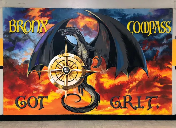 Dragon holding compass with fiery sky background by Esther Stimphat