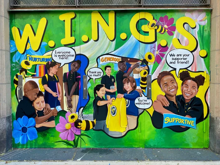 WINGS mural showing diverse people with supportive messages by Esther Stimphat