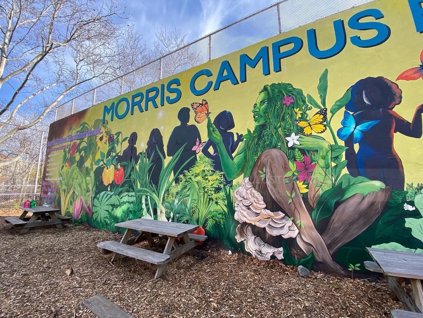 Colorful mural with diverse silhouettes and plants by Esther Stimphat
