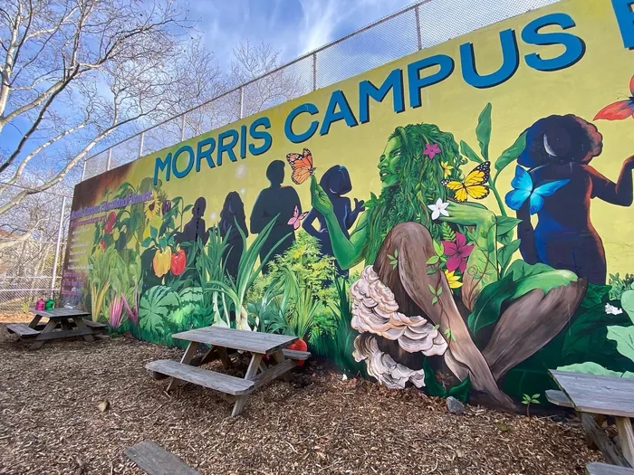 Colorful mural with diverse silhouettes and plants by Esther Stimphat