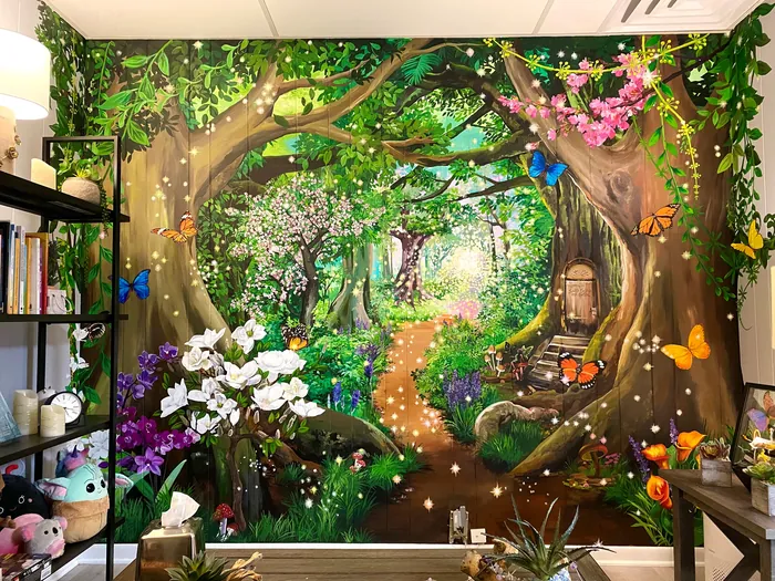 Colorful forest mural with trees, flowers, butterflies, and small animals.