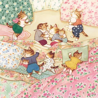 Kittens playing and climbing on floral blankets and pillows.