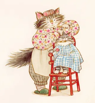 Two cats, one grooming the other sitting in a red chair