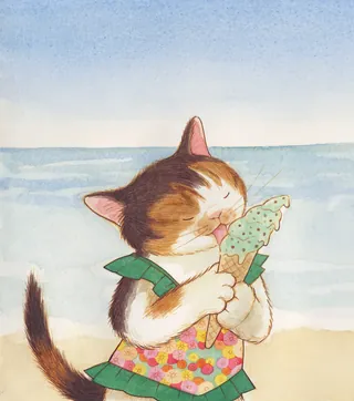 Kitten licking ice cream cone at the beach
